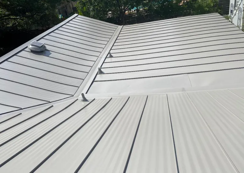 Solar attic fan installed on a metal roof for Roof Ventilation in Hallandale Beach